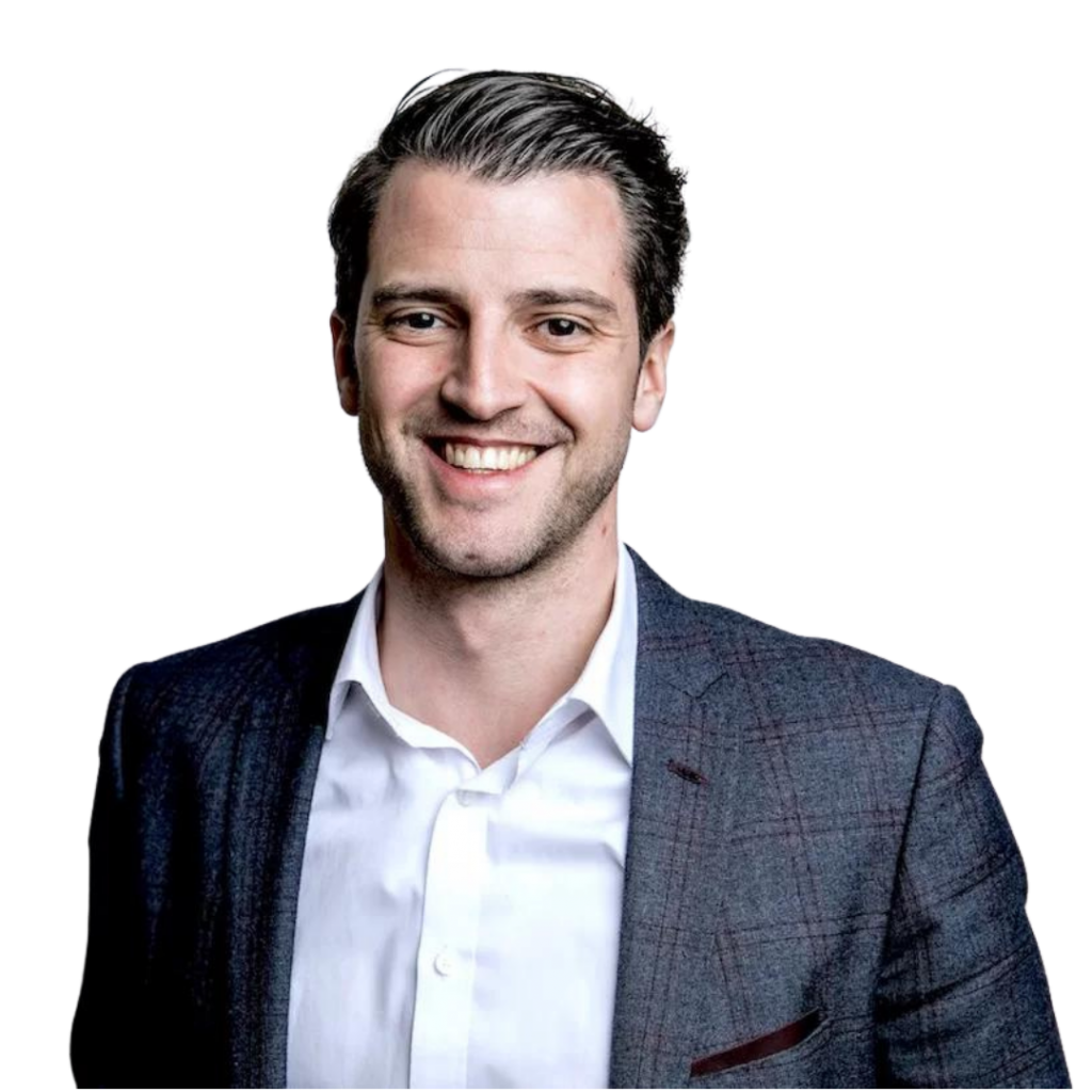 Custom WordPress Web Design USA – Secure & SEO-Ready 2 Headshot of a smiling man with dark hair wearing a suit jacket and white shirt against a black background.